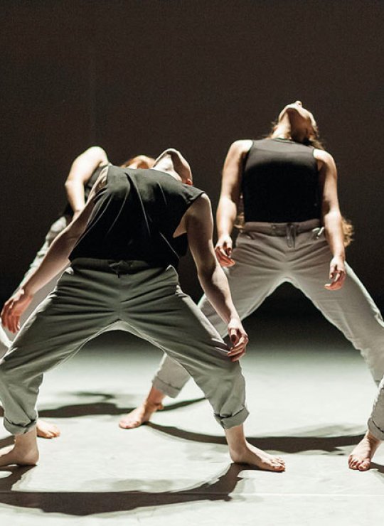 Dance students arching bodies backwards
